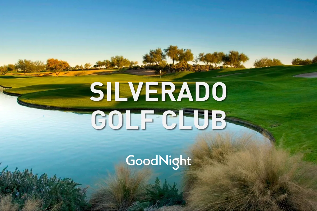 A serene golf course with a lush, green landscape, a reflective water body, and mature landscaped trees. The scene is tranquil, inviting visitors to relax, socialize, or enjoy a round of golf. The spacious greens suggest plenty of space for families or groups to spend time together outdoors.