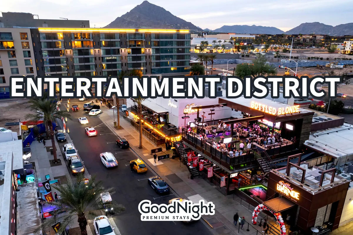 A dynamic exterior shot showcasing the entertainment district, with the Bottled Blonde restaurant sign, lively surroundings, and a backdrop of mountains. The area exudes energy, social opportunities, and diverse culinary experiences.